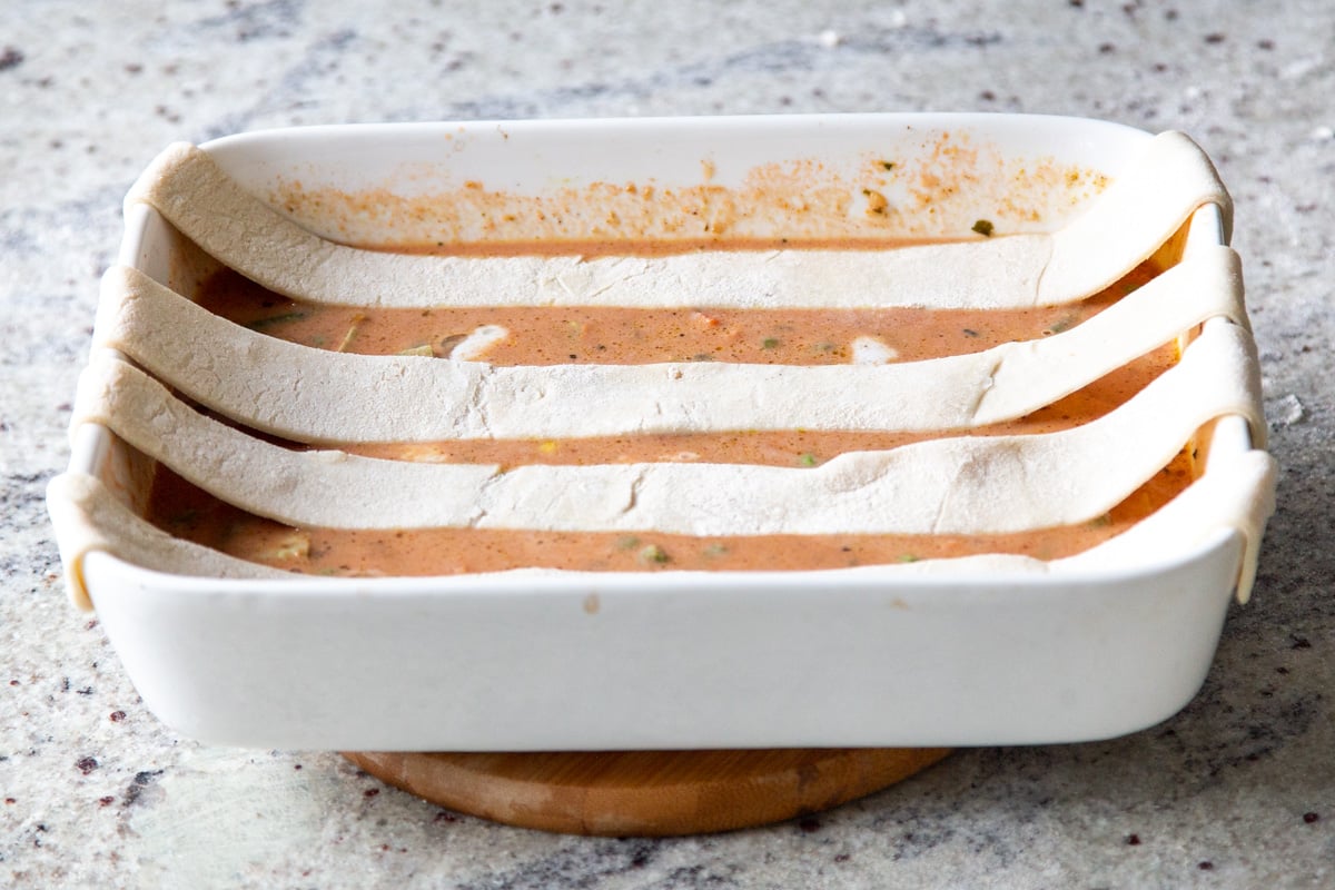 strips of puff pastry laid horizontally across the baking pan