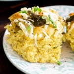 close-up of a coconut dinner roll on a plate, so you can see the inside texture