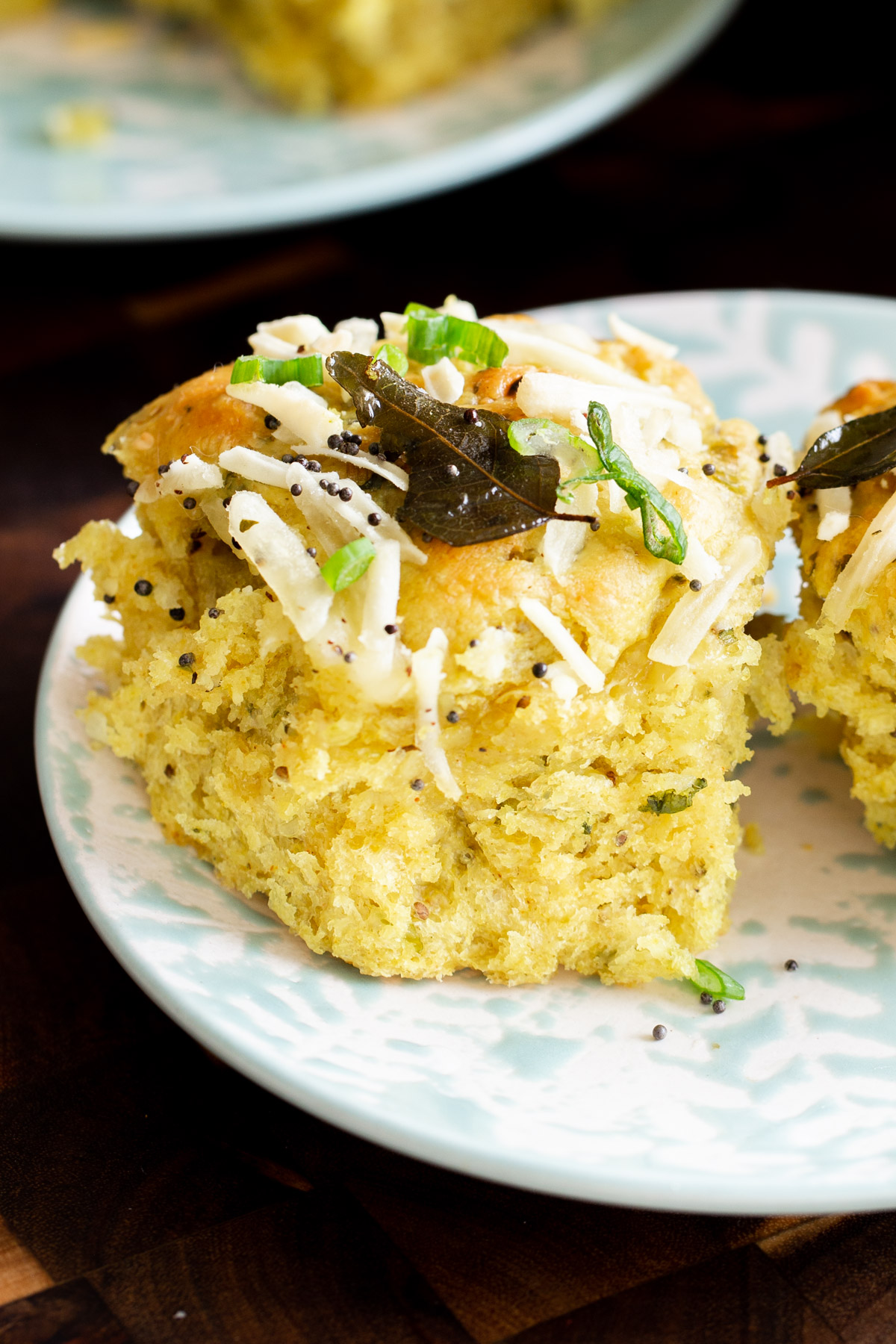 close-up of a coconut dinner roll on a plate, so you can see the inside texture