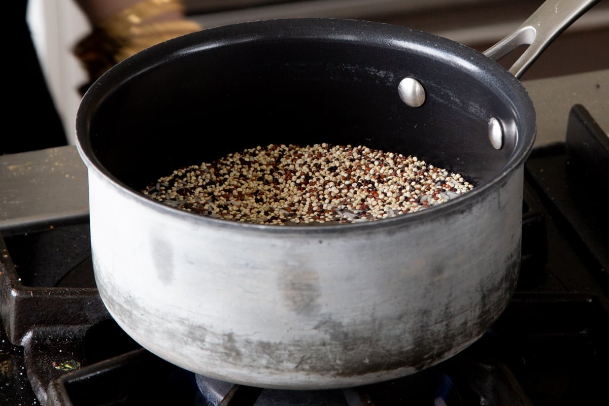 rice and quinoa in a pot on the stove before cooking