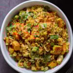 bowl of podi rice on the table with cilantro on top