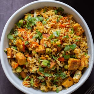bowl of podi rice on the table with cilantro on top