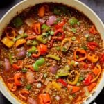 gochujang lentils in the pan with bell pepper and onion