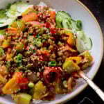 close-up of gochujang lentils in a bowl with bell pepper and onion