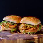 gochujang tofu banh mi with pickled veggies on a wooden cutting board