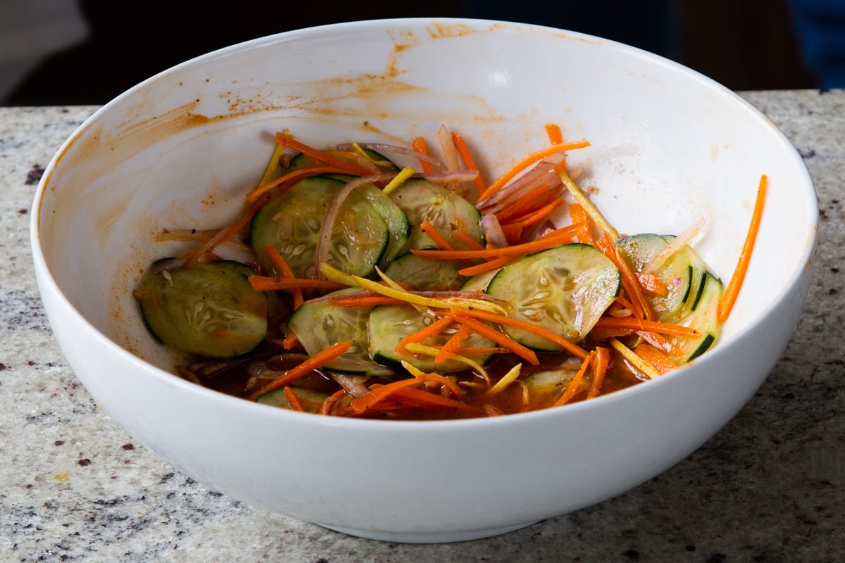 onions added with cucumbers and carrots to the marinade, after mixing