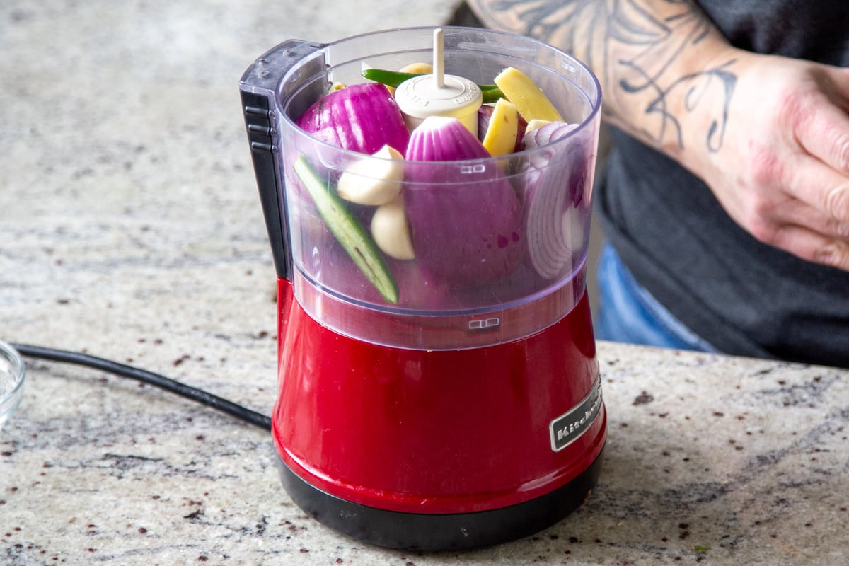 onions, garlic, ginger, and chili in a food processor before blending