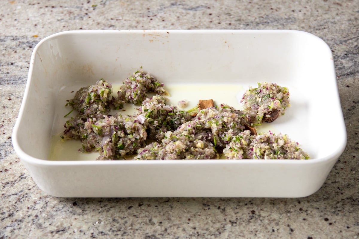 chopped aromatics added to the baking pan