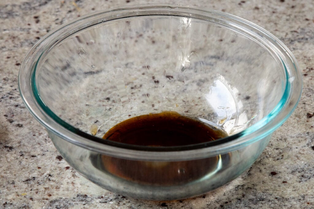 oil, vanilla, and maple syrup mixed together in a small glass bowl