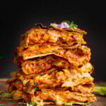 stack of vegan pizza quesadilla slices on a wooden cutting board