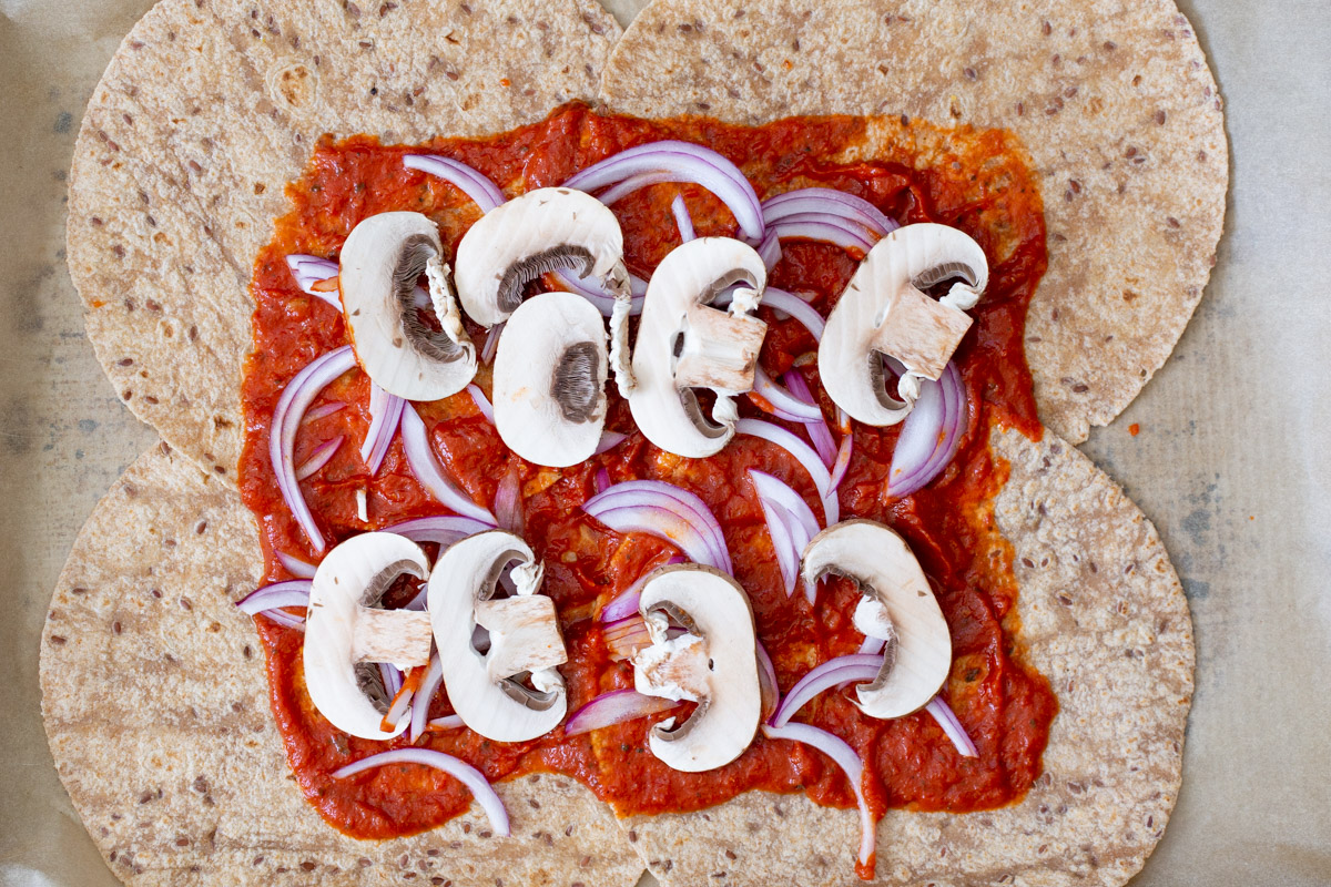 adding the mushrooms to the tortillas