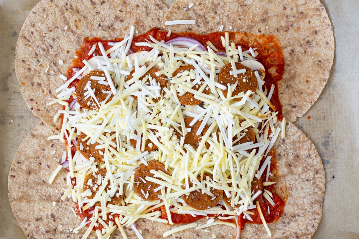 more vegan cheese sprinkled onto the pepperoni