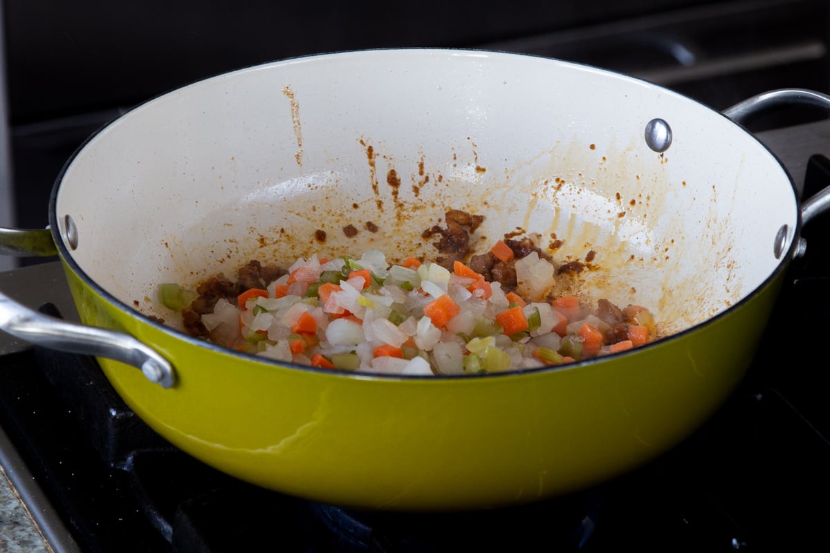 adding the veggies to the pan