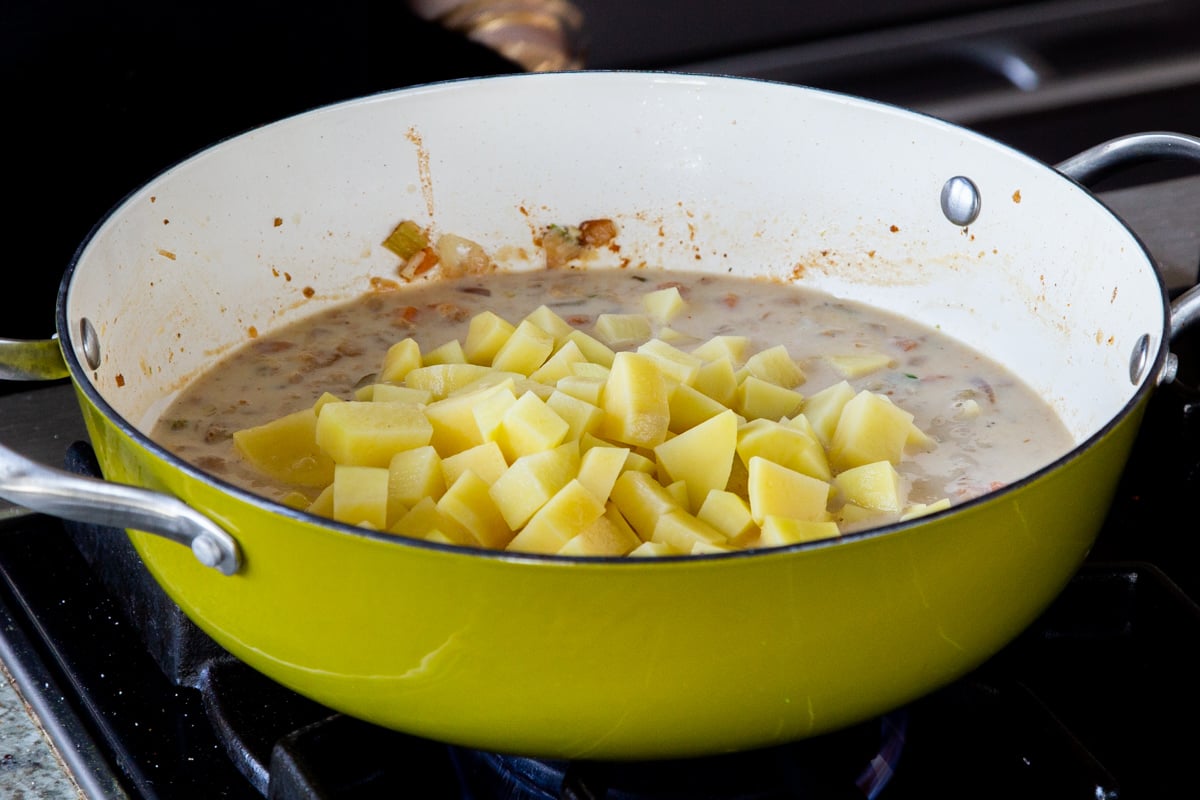 adding the potatoes to the soup base