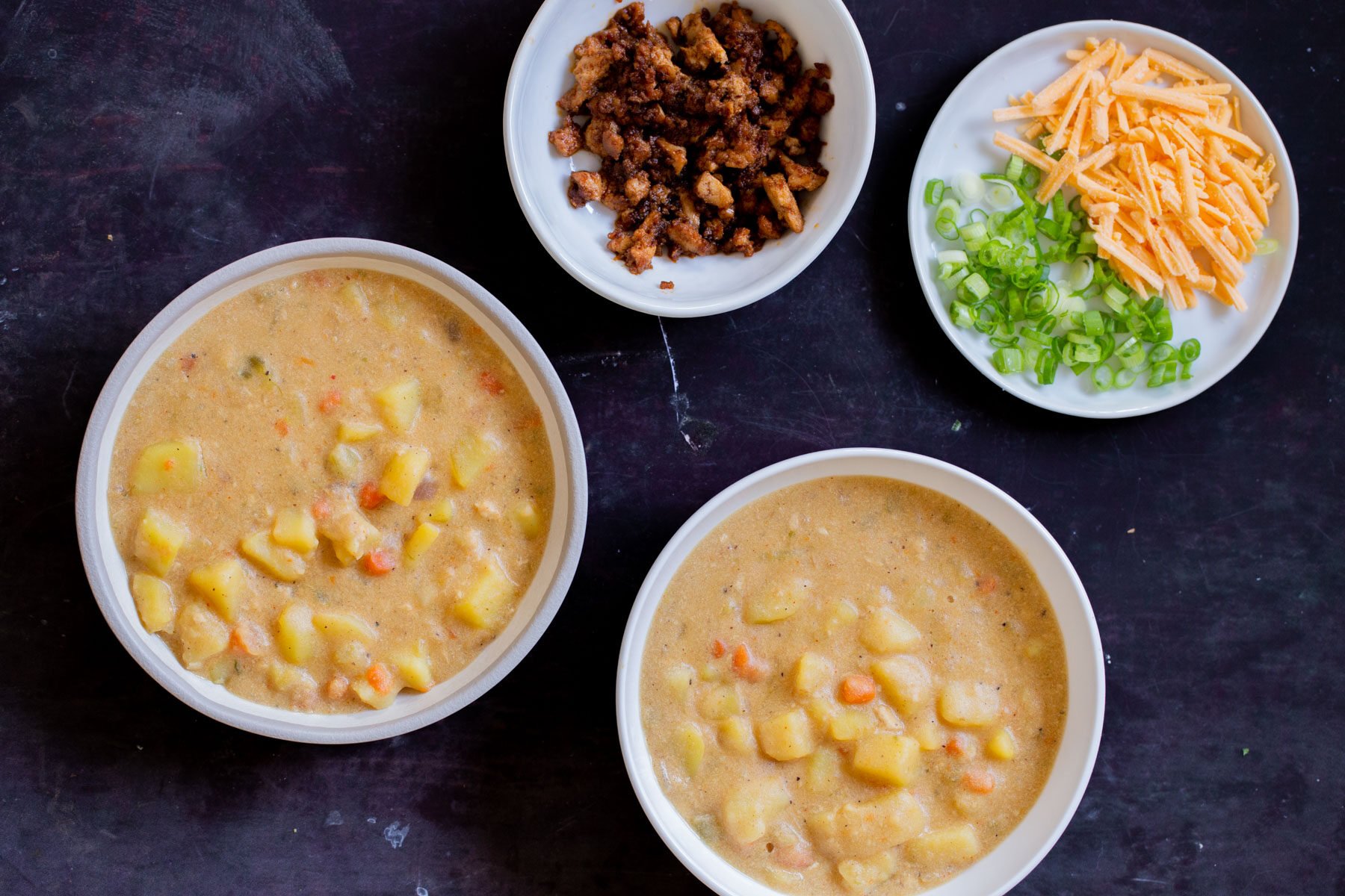 bowls of vegan potato soup before adding toppings