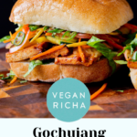 gochujang sandwich with pickled veggies on a wooden cutting board, text overlay