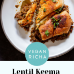 Lentil Keema Pav Casserole on the plate with a bite taken out, text overlay