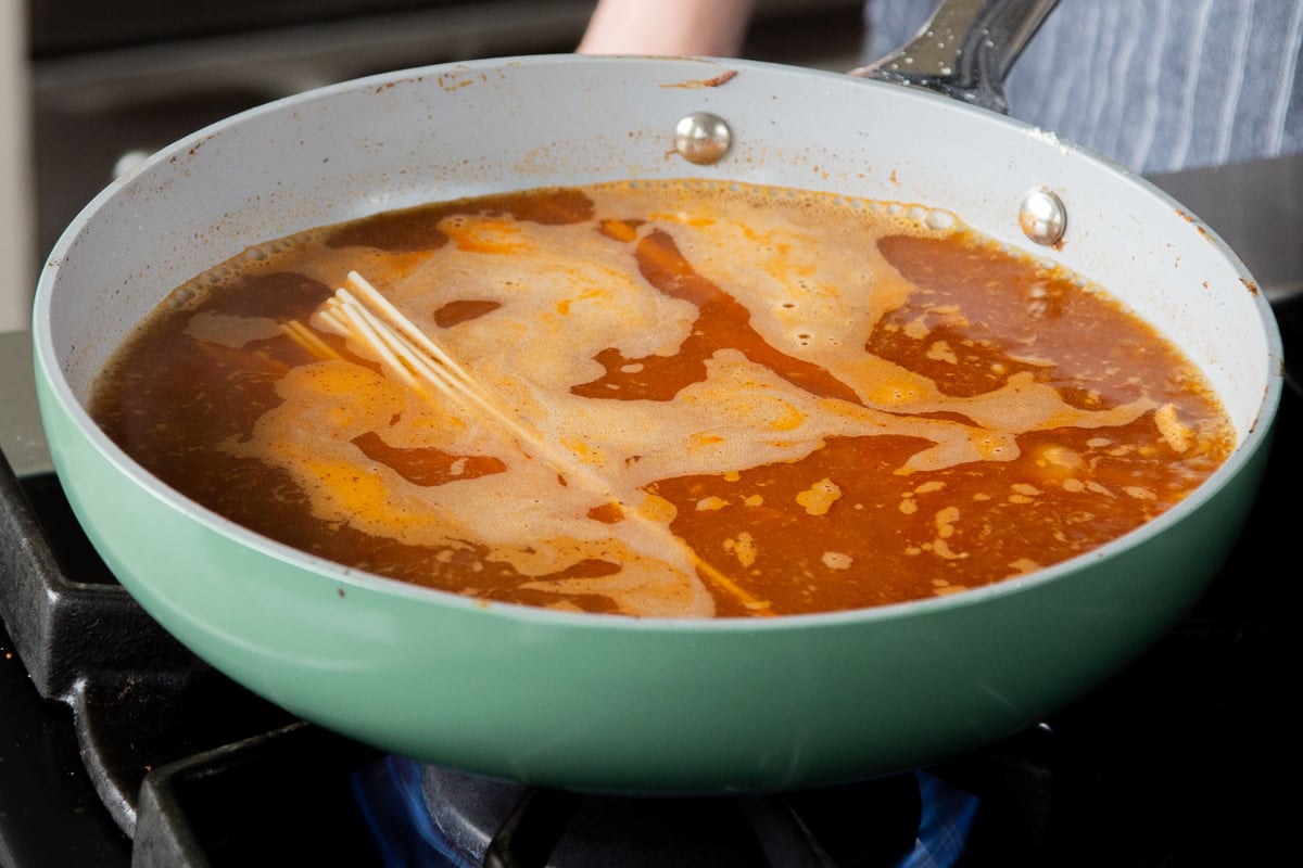 adding ramen to the birria broth