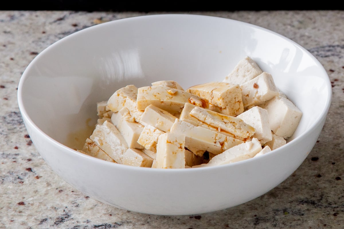 tofu pieces in a bowl with soy sauce and lime juice