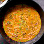 butter ramen in the wok after cooking, with garnishes