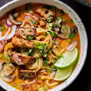 bowl of butter ramen with tofu and a lime wedge