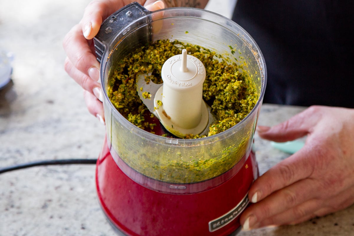 peanuts, sesame seeds, and spices in the food processor after grinding