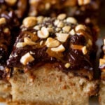 close-up of sliced Snickers cake on a white serving tray