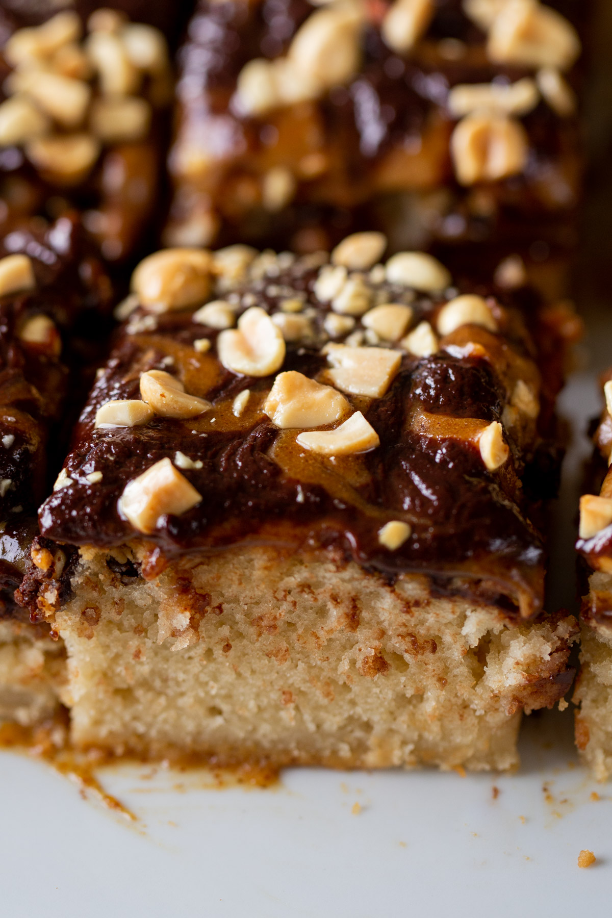 close-up of sliced Snickers cake on a white serving tray