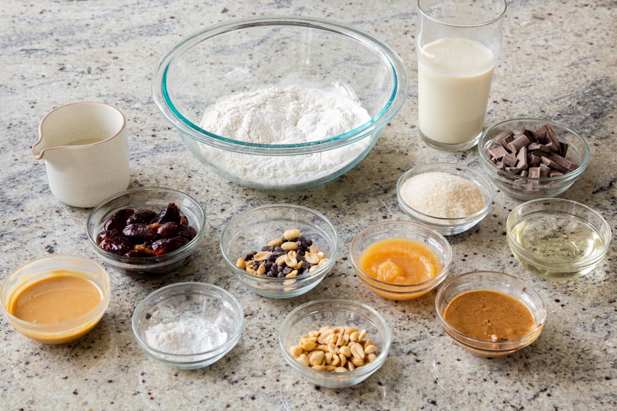 Snickers cake ingredients in bowls on a kitchen countertop