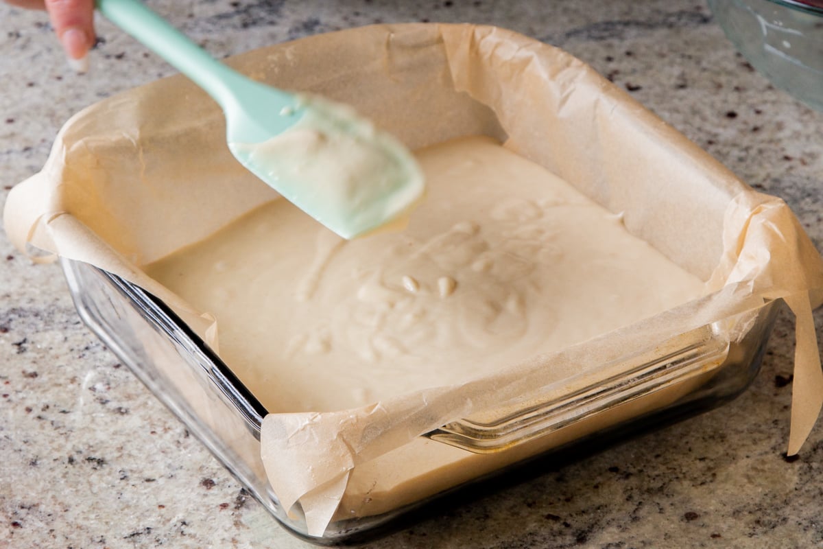 cake batter in a lined baking pan