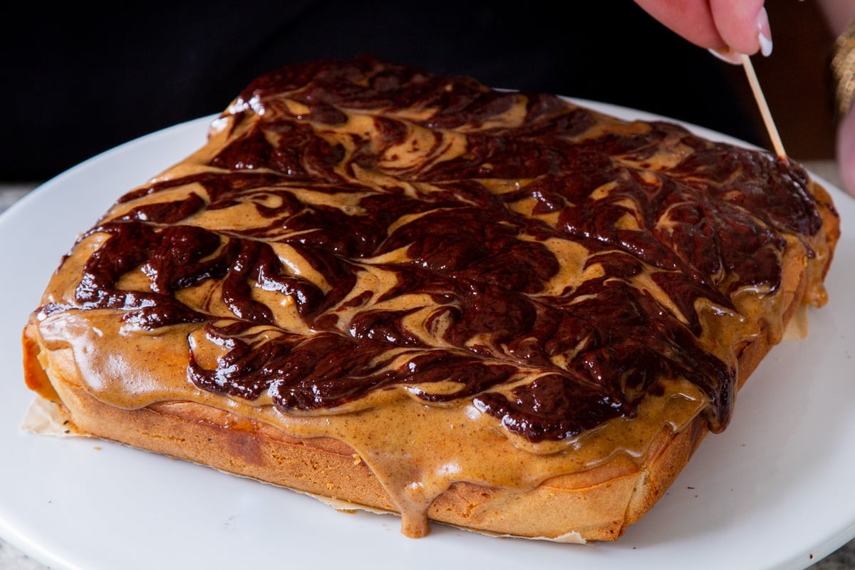 chocolate and caramel topping on the cake, after swirling them together