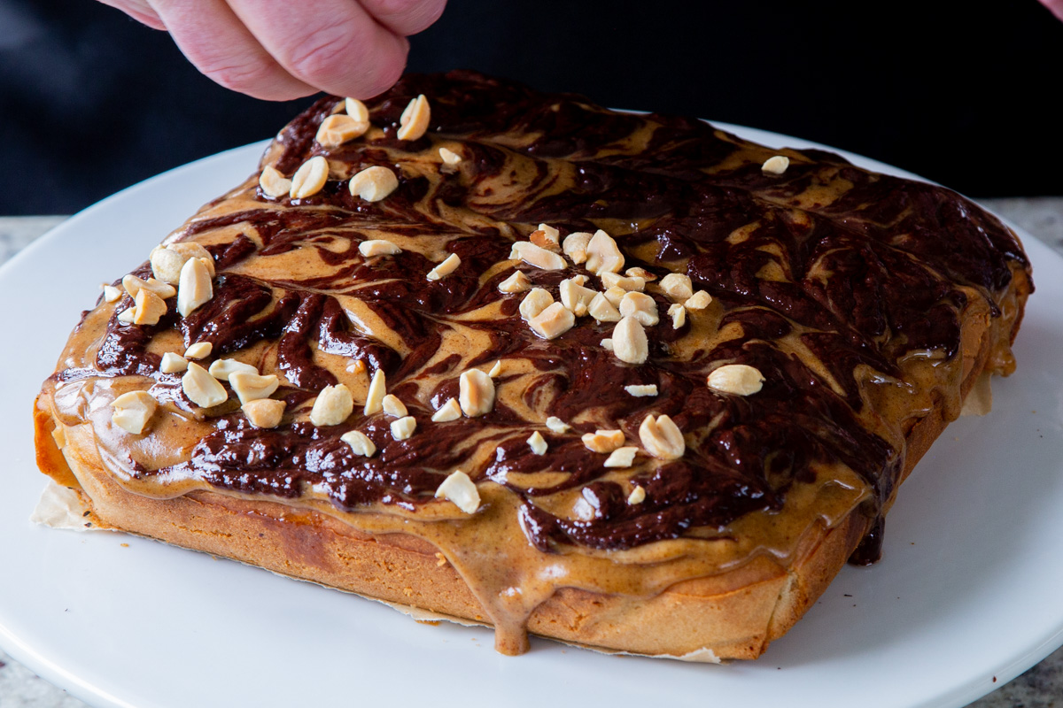 adding peanuts to the cake