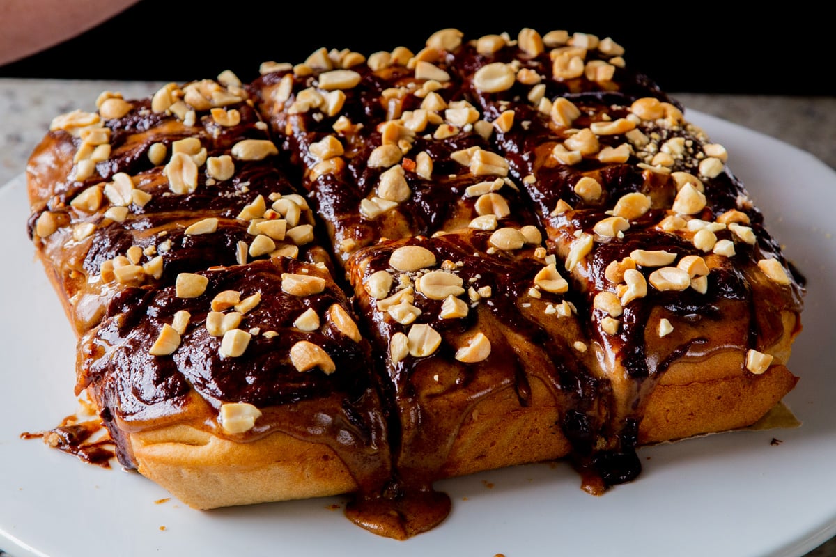 Snickers cake topped with peanuts, after slicing