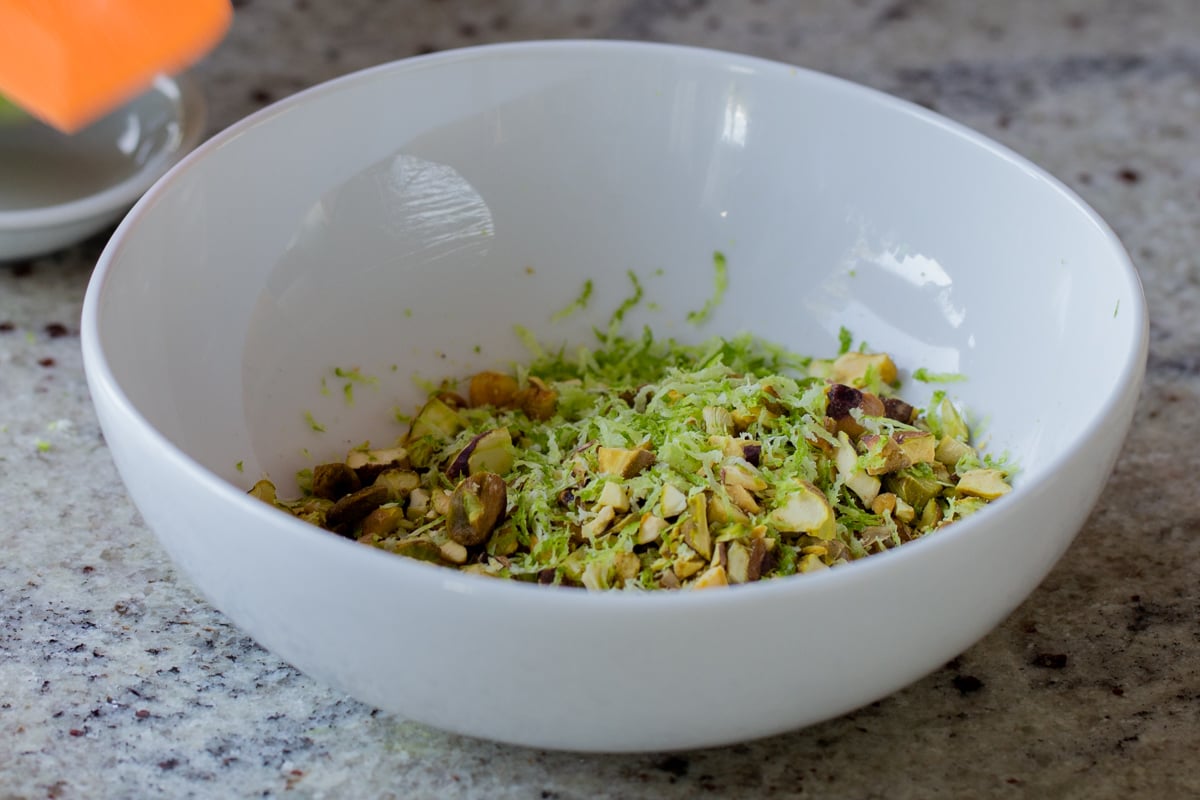 lime zest and chopped pistachios in the bowl