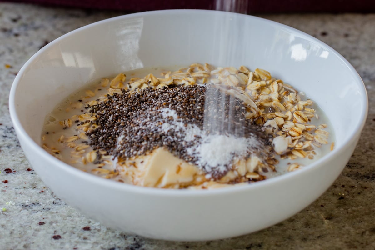 adding chia seeds and vanilla powder to the oats