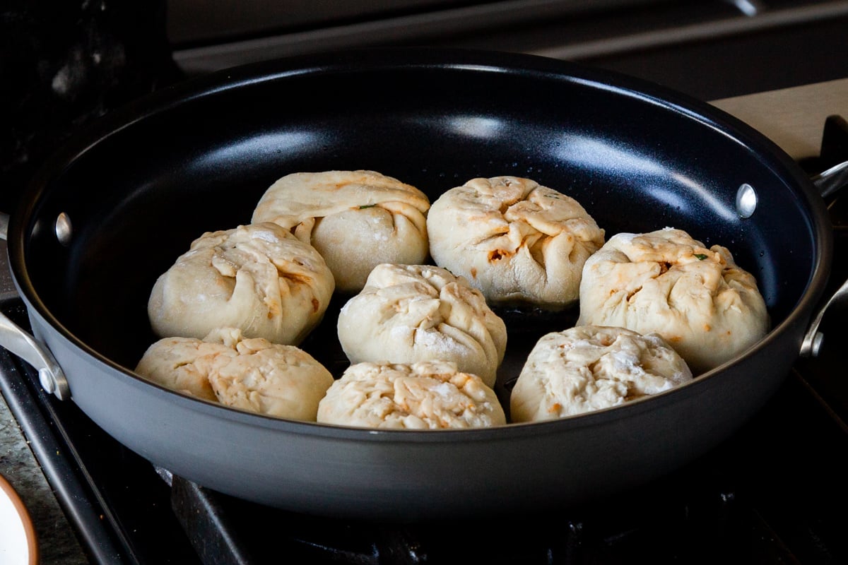 butter chicken bao in the pan, as you brown the bottoms