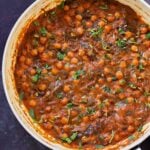 panful of harissa chickpeas after cooking with cilantro garnish