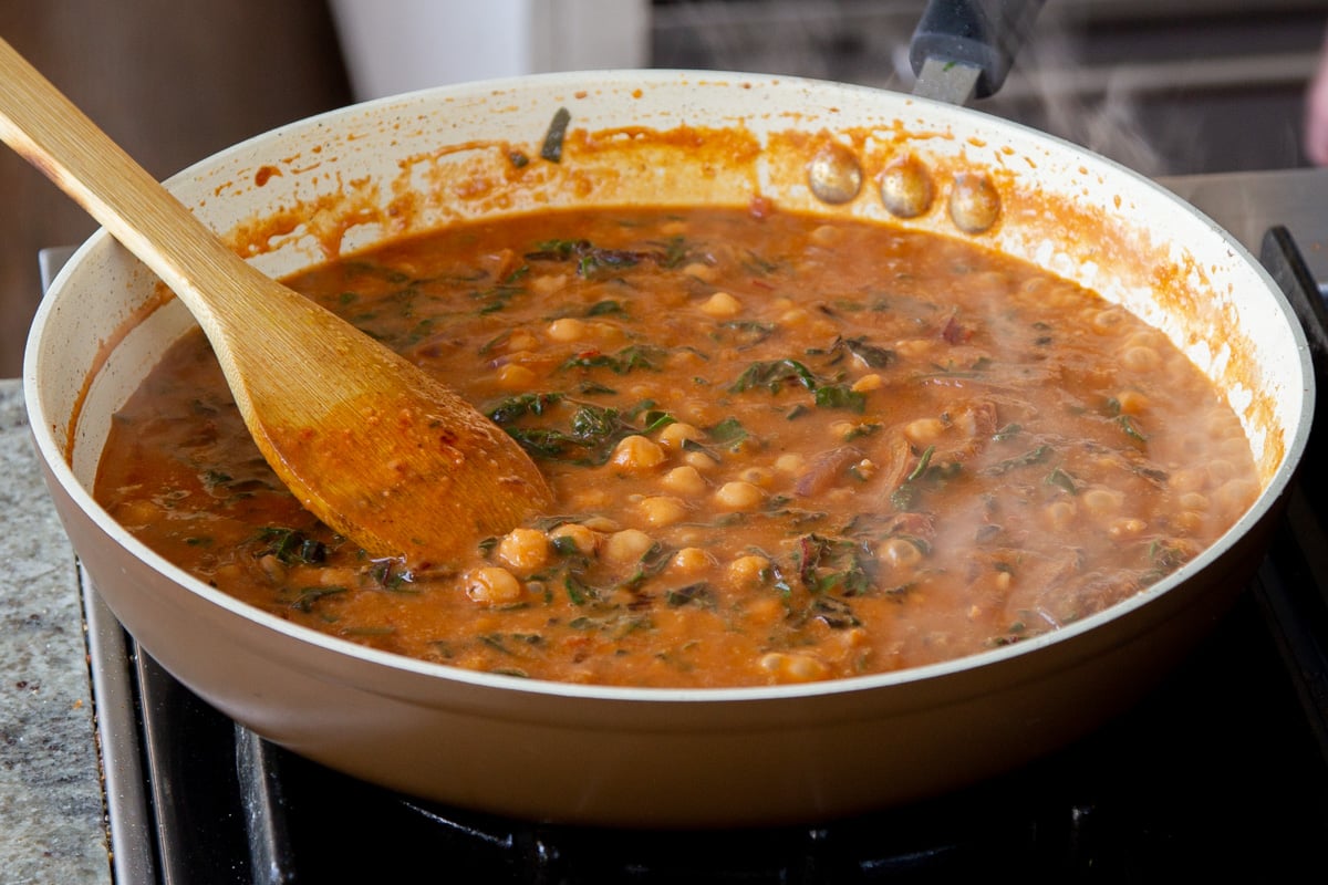 Swiss chard and chickpeas in the pan of harissa sauce, after cooking
