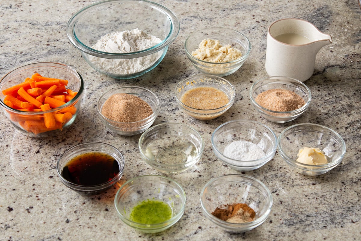 carrots, flour, and other cake ingredients on a kitchen counter