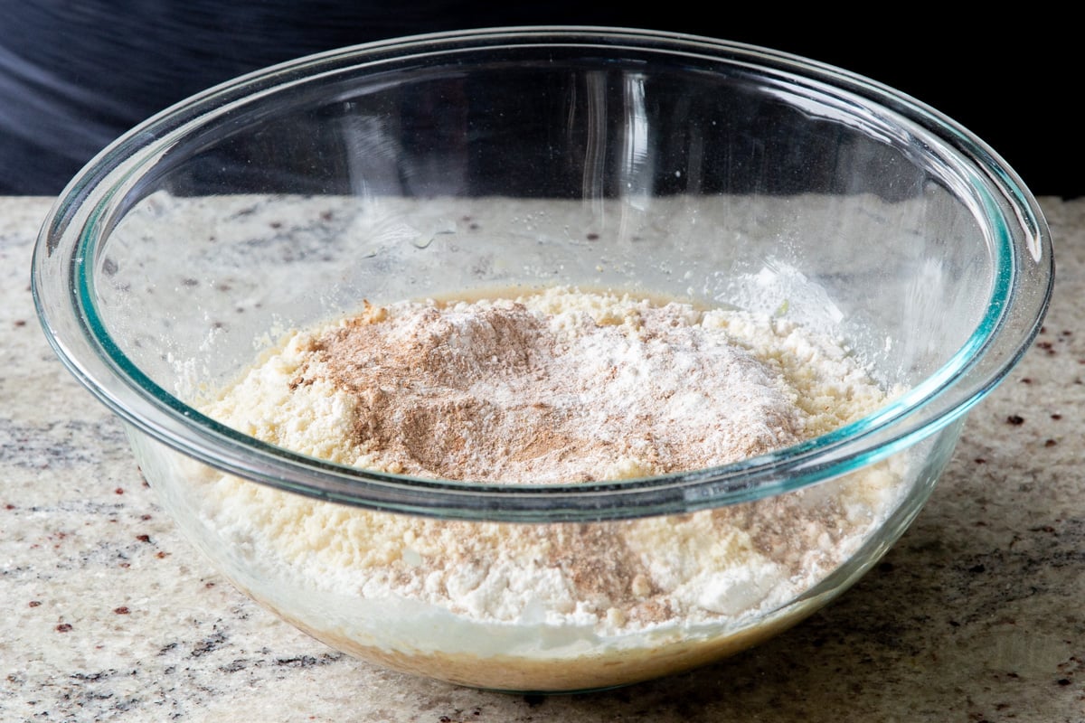 adding the remaining dry cake ingredients to the mixing bowl