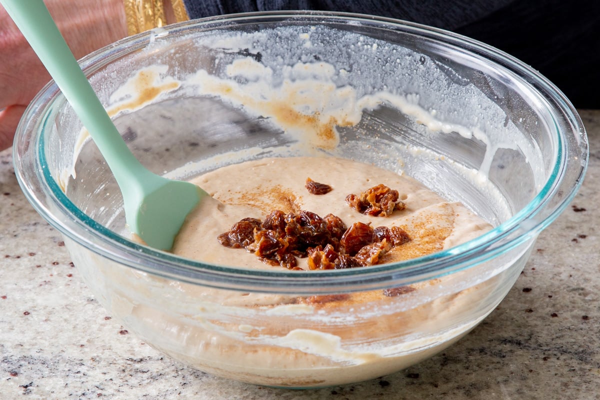 adding the raisins to the cake batter