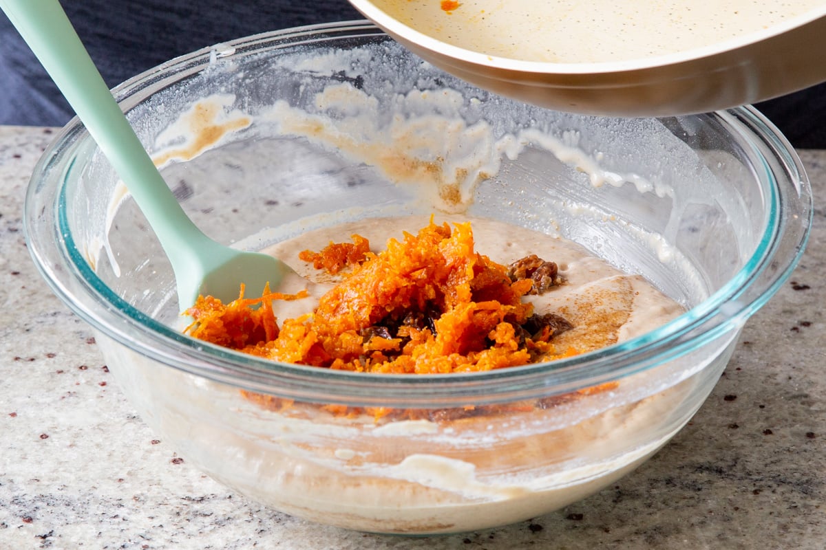 adding some of the carrot halwa to the cake batter