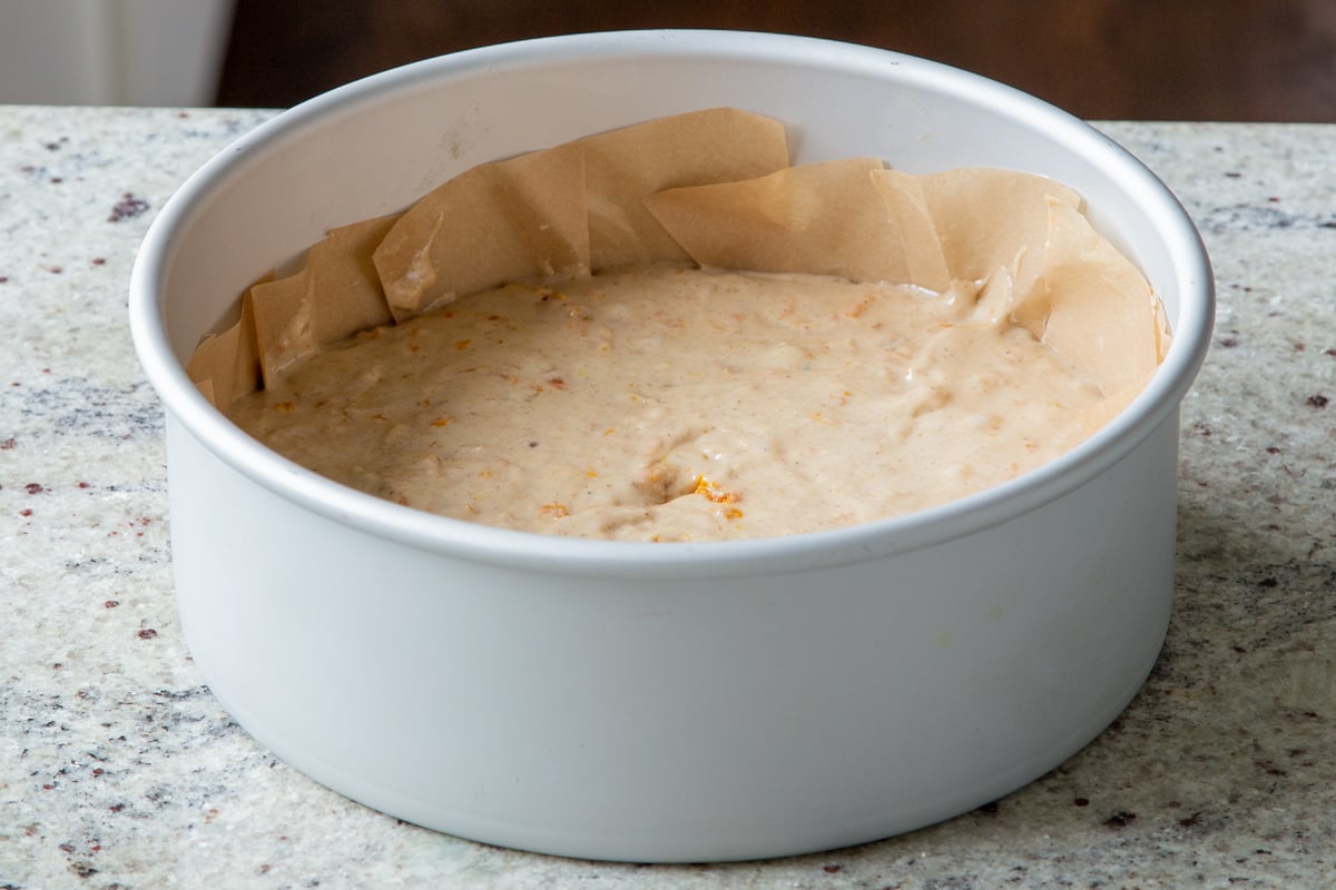 cake batter in a lined metal cake pan