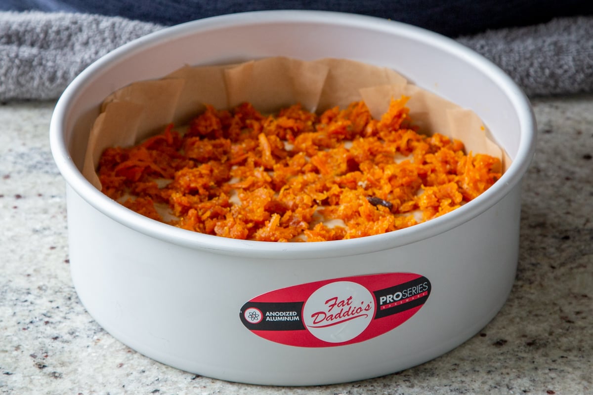 cake batter topped with remaining carrot halwa mixture