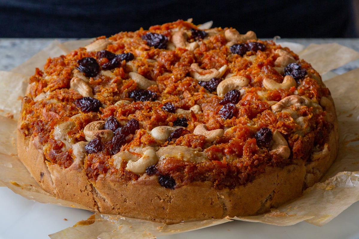 carrot halwa cake on parchment paper, after baking and cooling