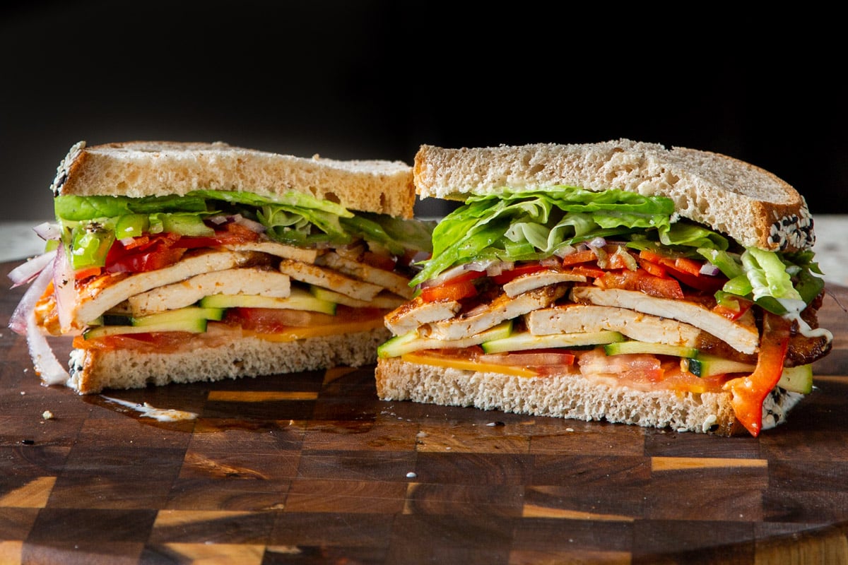 vegan club sandwich sliced in half, so you can see the fillings