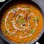 dal lasooni in the pan with cilantro and a swirl of cream