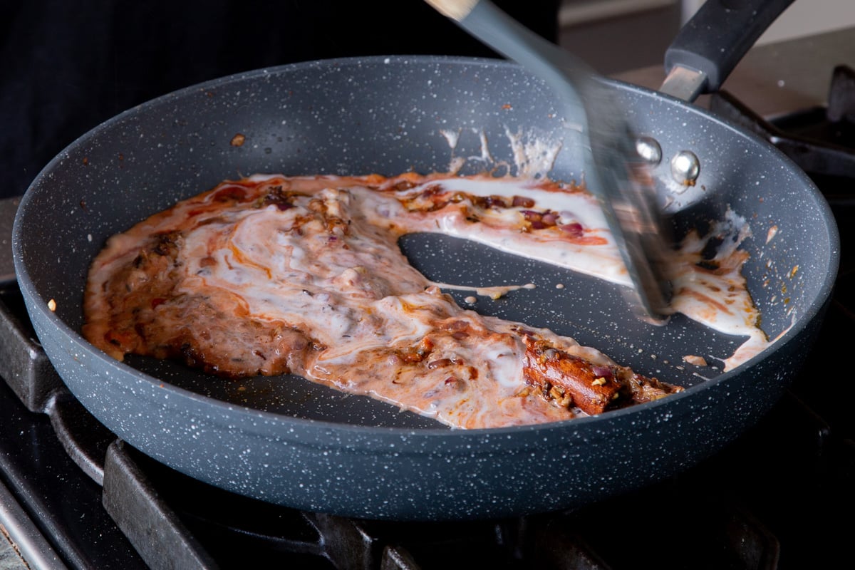 mixing the sauce together in the pan