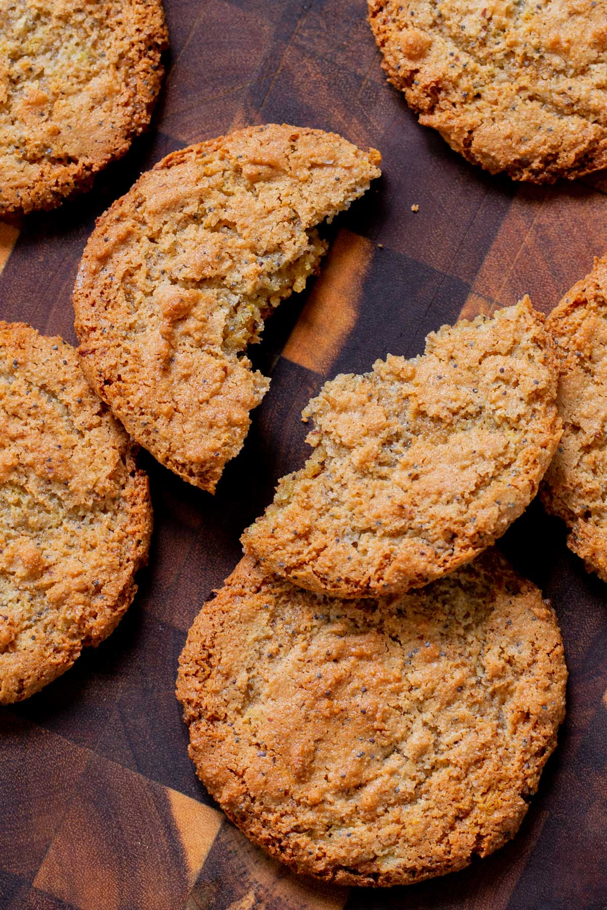 vegan lemon cookie broken in half on a wooden table