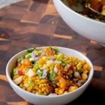 bowl of moong dal chaat next to the serving bowl